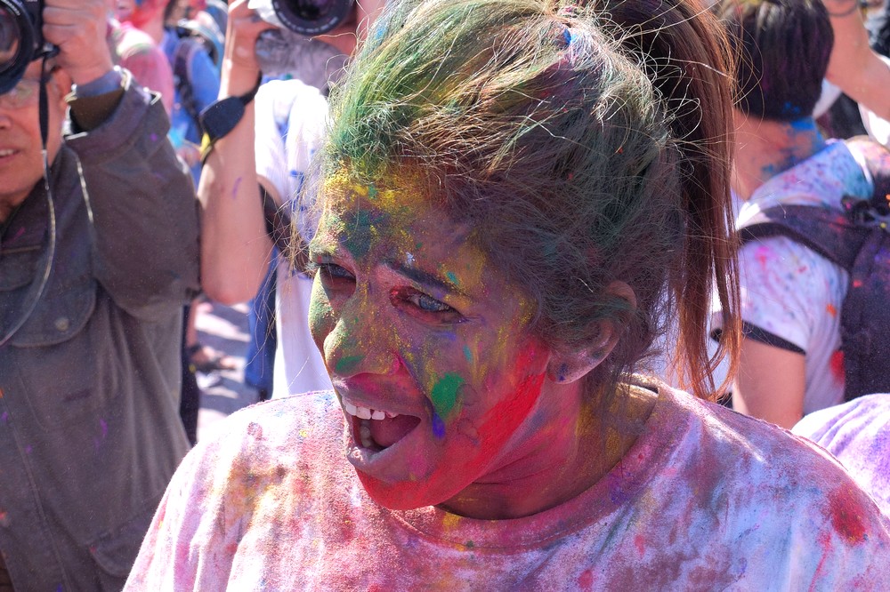 A girl with mouth full of colorful powder - Kathmandu - Holi in Nepal