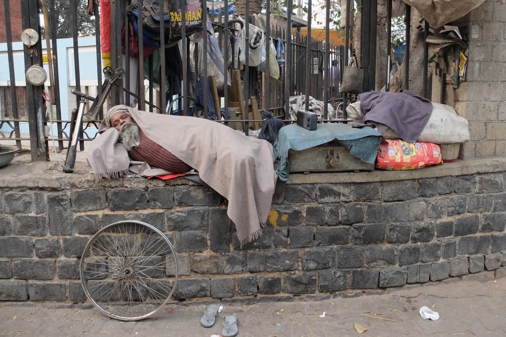 man sleeping on the street Delhi