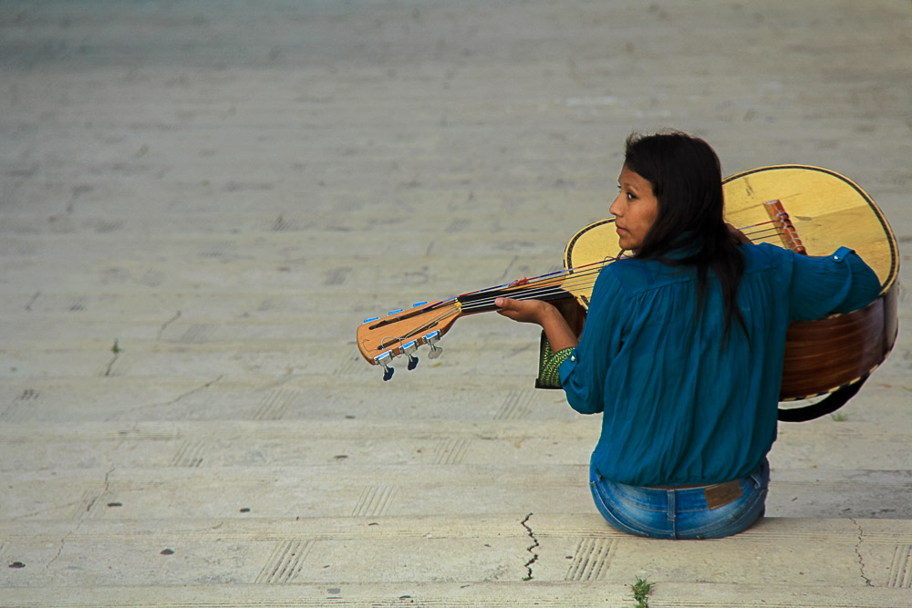 Woman playing guitar - Nomadic Traveler Ray Gudrups